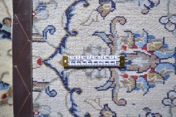 Corner detail of 2000s Kashan rug showing border pattern and Wool pile