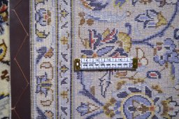 Corner detail of 2000s Kashan rug showing border pattern and Wool pile