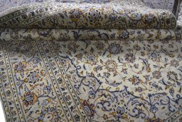 Close-up detail of 2000s Kashan rug from Iran / Persia showing Wool weave