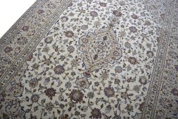 Backside of handmade 2000s Kashan rug showing knot structure and weave density