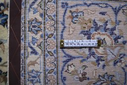 Corner detail of 2000s Kashan rug showing border pattern and Wool pile