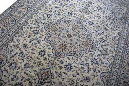 Backside of handmade 2000s Kashan rug showing knot structure and weave density