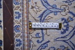 Corner detail of 2000s Kashan rug showing border pattern and Wool pile