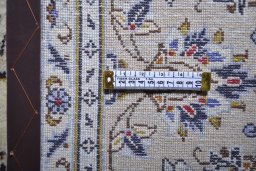 Corner detail of 2000s Kashan rug showing border pattern and Wool pile
