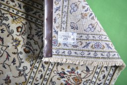 Backside of handmade 2000s Kashan rug showing knot structure and weave density