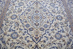 Backside of handmade 2000s Kashan rug showing knot structure and weave density