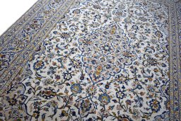 Backside of handmade 2000s Kashan rug showing knot structure and weave density