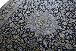 Backside of handmade 2000s Kashan rug showing knot structure and weave density