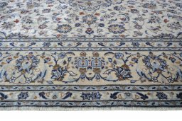 Corner detail of 2000s Kashan rug showing border pattern and Wool pile