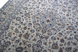 Backside of handmade 2000s Kashan rug showing knot structure and weave density