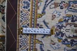 Corner detail of 2000s Kashan rug showing border pattern and Wool pile