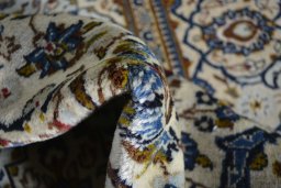 Surface texture of 2000s Kashan rug with natural Wool and intricate pattern