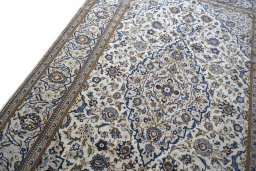 Backside of handmade 2000s Kashan rug showing knot structure and weave density