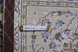 Corner detail of 2000s Kashan rug showing border pattern and Wool pile