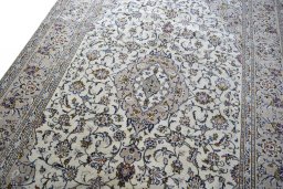 Backside of handmade 2000s Kashan rug showing knot structure and weave density