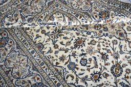 Corner detail of 2000s Kashan rug showing border pattern and Wool pile