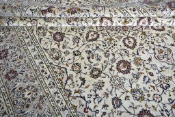 Corner detail of 2000s Kashan rug showing border pattern and Wool pile