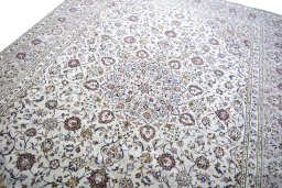 Backside of handmade 2000s Kashan rug showing knot structure and weave density