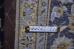 Corner detail of 2000s Kashan rug showing border pattern and Wool pile