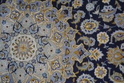 Backside of handmade 2000s Kashan rug showing knot structure and weave density