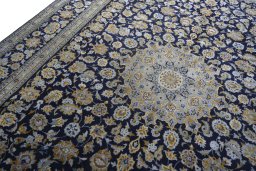 Backside of handmade 2000s Kashan rug showing knot structure and weave density
