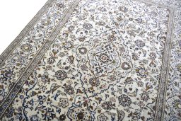 Backside of handmade 2000s Kashan rug showing knot structure and weave density