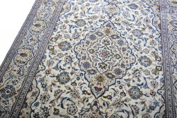 Backside of handmade 2000s Kashan rug showing knot structure and weave density