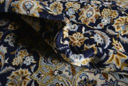 Close-up detail of 2000s Kashan rug from Iran / Persia showing Wool weave