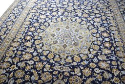 Backside of handmade 2000s Kashan rug showing knot structure and weave density
