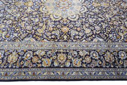 Corner detail of 2000s Kashan rug showing border pattern and Wool pile