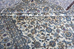 Corner detail of 2000s Kashan rug showing border pattern and Wool pile