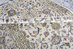 Corner detail of 2000s Kashan rug showing border pattern and Wool pile