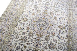 Backside of handmade 2000s Kashan rug showing knot structure and weave density