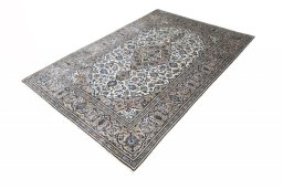 Corner detail of 2000s Kashan rug showing border pattern and Wool pile