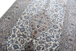 Backside of handmade 2000s Kashan rug showing knot structure and weave density