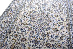 Backside of handmade 2000s Kashan rug showing knot structure and weave density