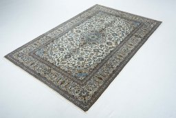 Corner detail of 2000s Kashan rug showing border pattern and Wool pile