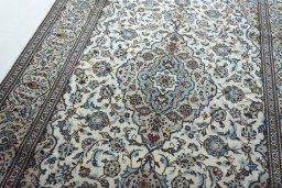 Backside of handmade 2000s Kashan rug showing knot structure and weave density
