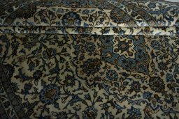 Corner detail of 2000s Kashan rug showing border pattern and Wool pile