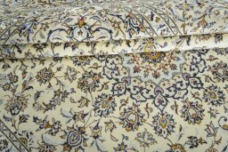 Backside of handmade 2000s Kashan rug showing knot structure and weave density