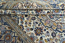 Corner detail of 2000s Kashan rug showing border pattern and Wool pile