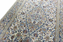 Backside of handmade 2000s Kashan rug showing knot structure and weave density