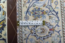Backside of handmade New Kashan rug showing knot structure and weave density