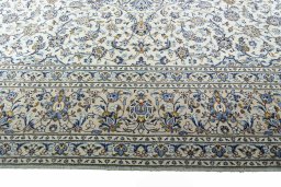 Corner detail of 2000s Kashan rug showing border pattern and Wool pile