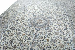 Backside of handmade 2000s Kashan rug showing knot structure and weave density