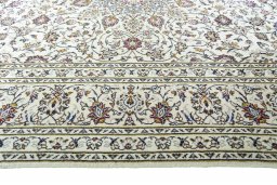 Corner detail of 2000s Kashan rug showing border pattern and Wool pile