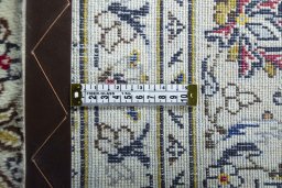 Backside of handmade 2000s Kashan rug showing knot structure and weave density