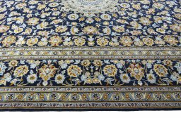 Corner detail of 2000s Kashan rug showing border pattern and Wool pile