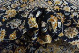 Backside of handmade 2000s Kashan rug showing knot structure and weave density