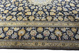 Corner detail of 2000s Kashan rug showing border pattern and Wool pile